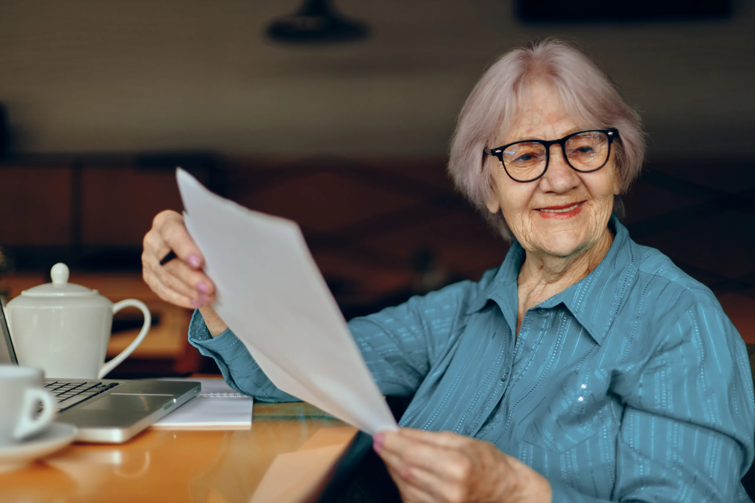 Beautiful mature senior woman in a cafe a cup of drink laptop Retired woman chatting unaltered